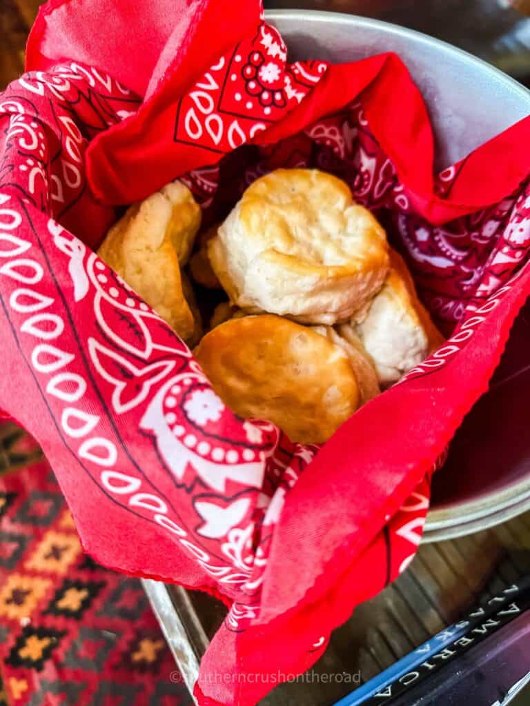 fresh hot homemade biscuits in metal bucket with red bandana