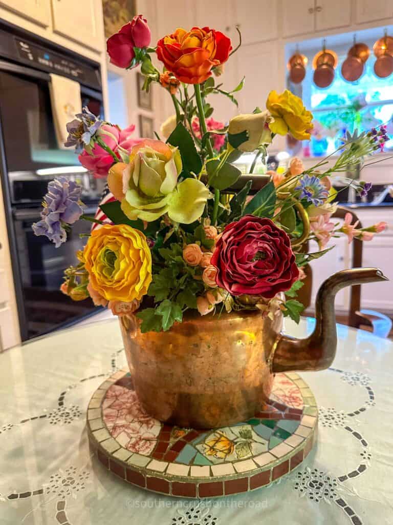 floral arrangment in copper teapot
